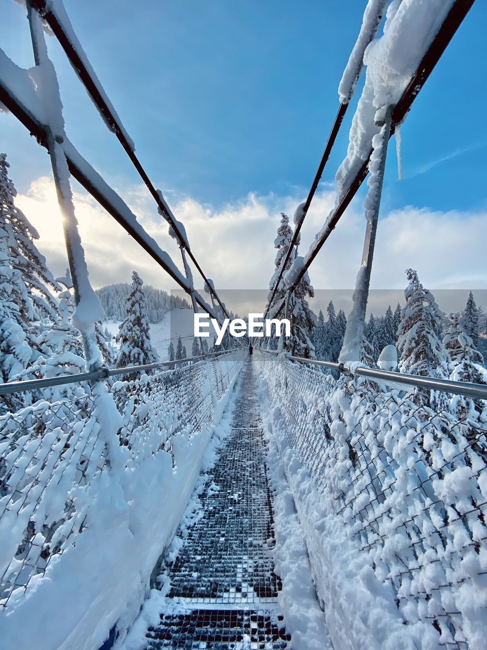 Snow covered bridge against sky