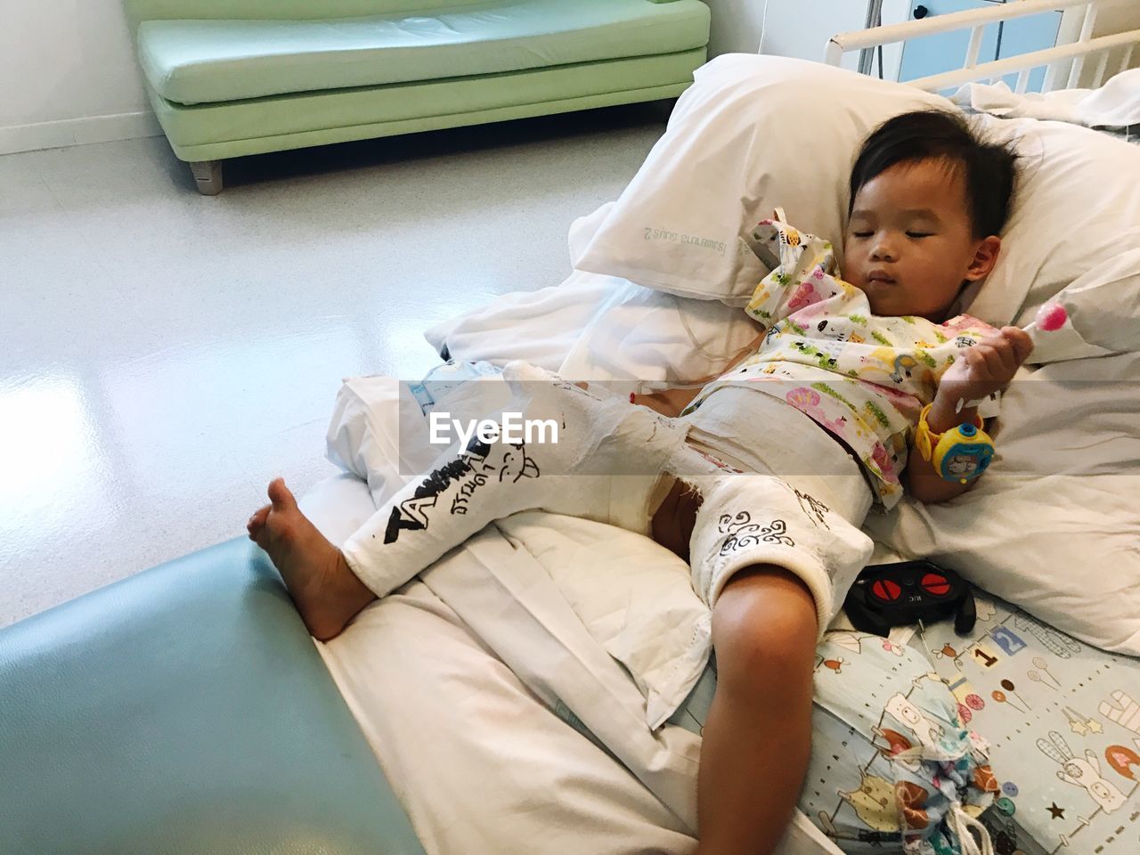 Young boy with leg cast in hospital bed