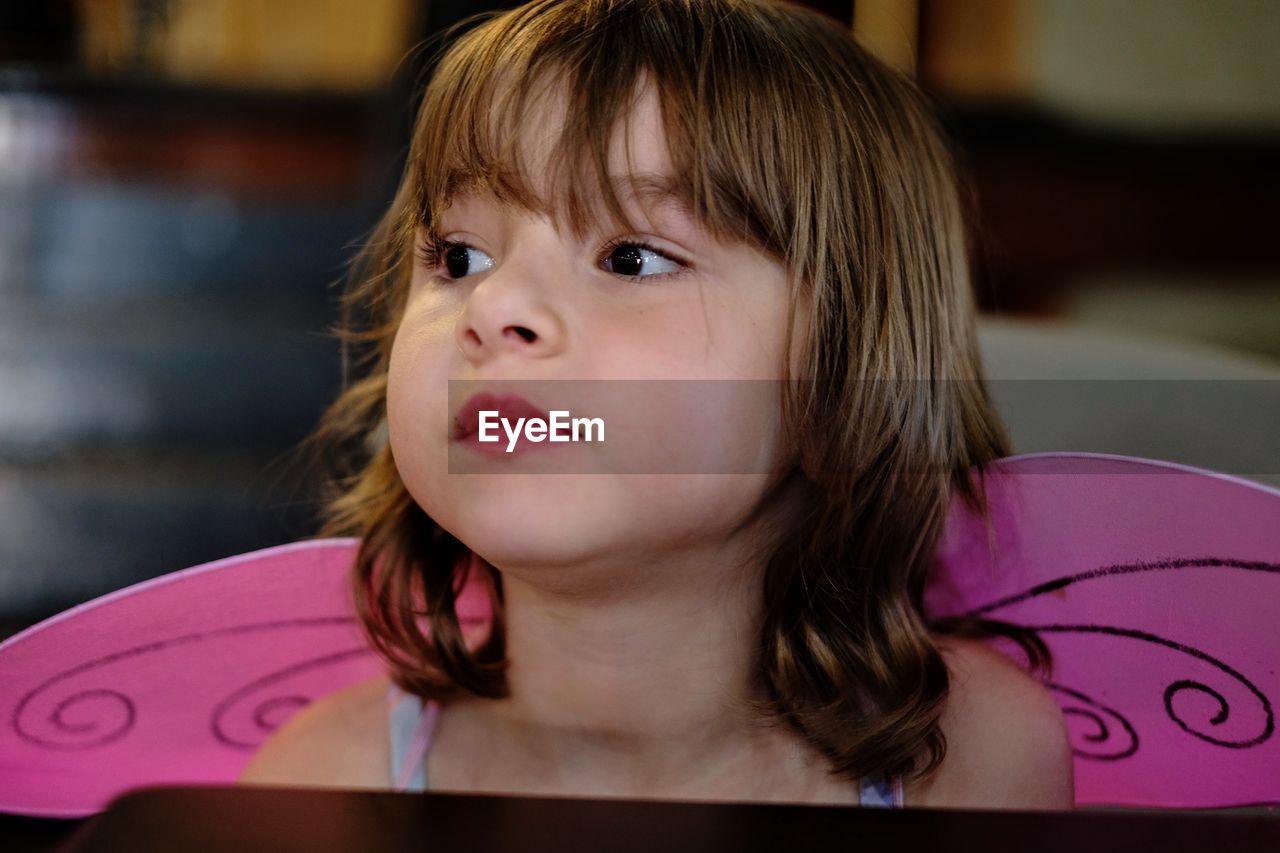 Close-up of girl with wings