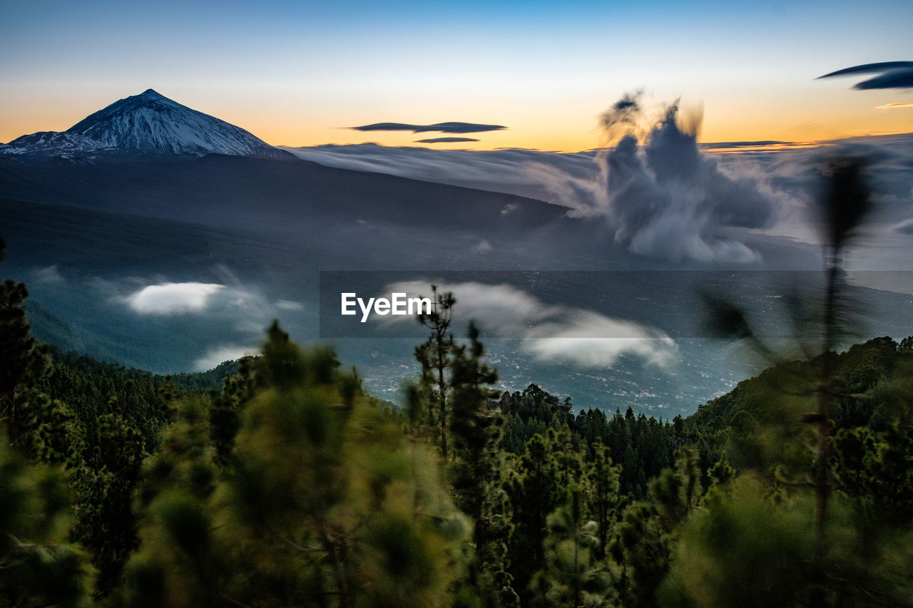 Panoramic view of volcanic mountain against sky during sunset