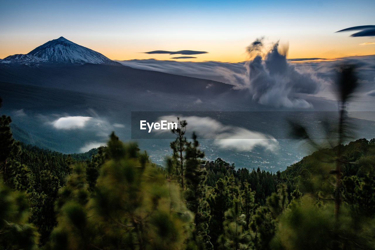 Panoramic view of volcanic mountain against sky during sunset