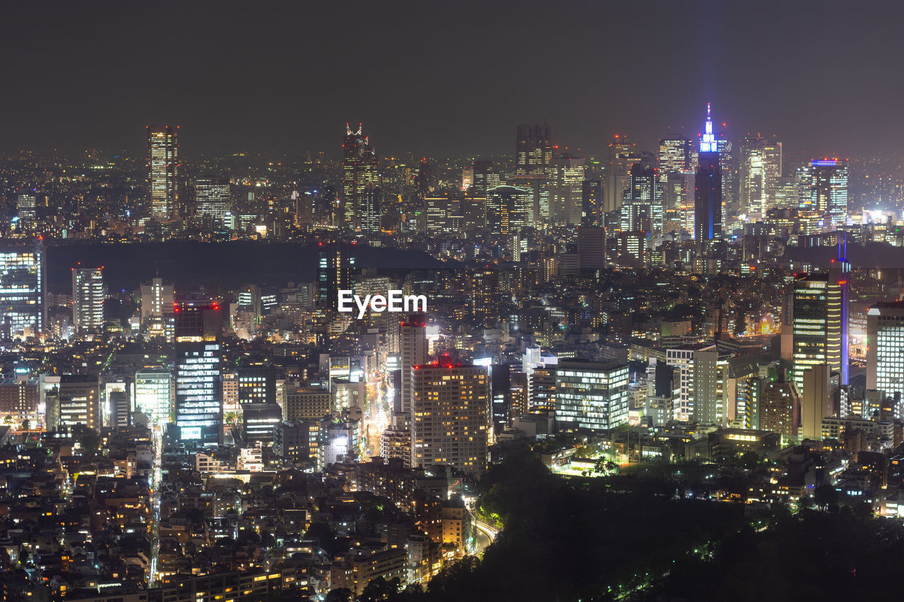 ILLUMINATED BUILDINGS AGAINST SKY AT NIGHT