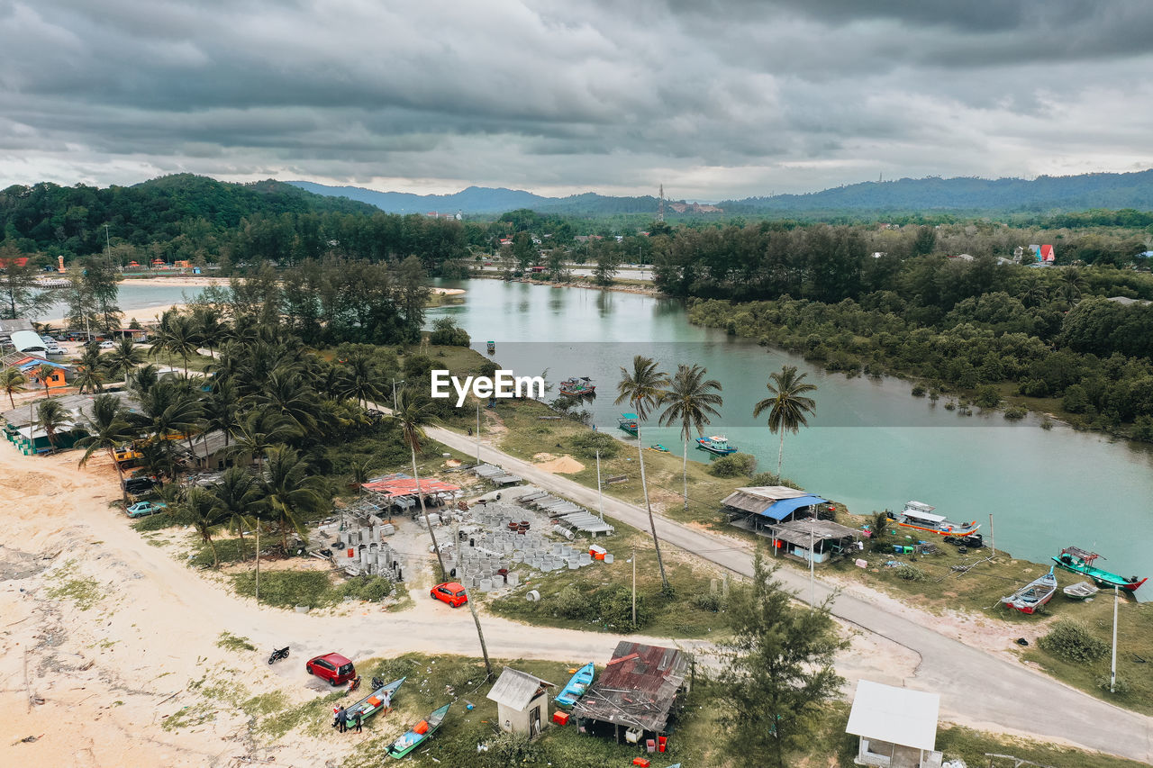 High angle view of townscape by lake against sky