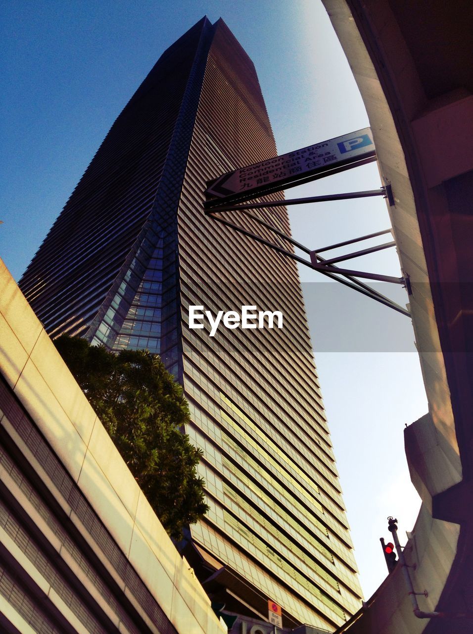 Low angle view of modern office building in city against sky