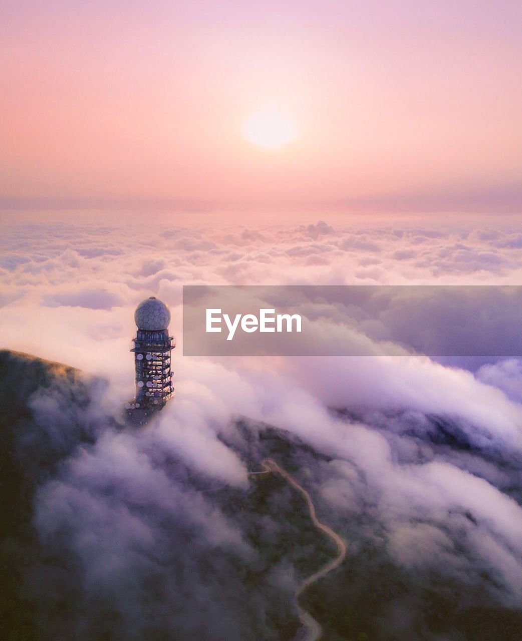 High angle view of communications tower on mountain in foggy weather