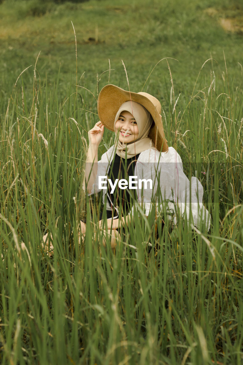 Portrait of a smiling young woman in field