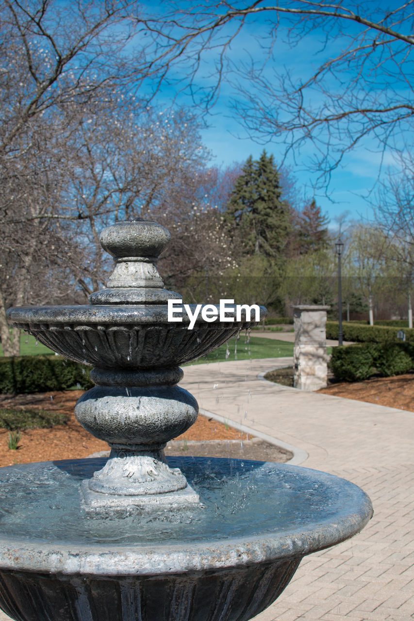 FOUNTAIN AGAINST TREES