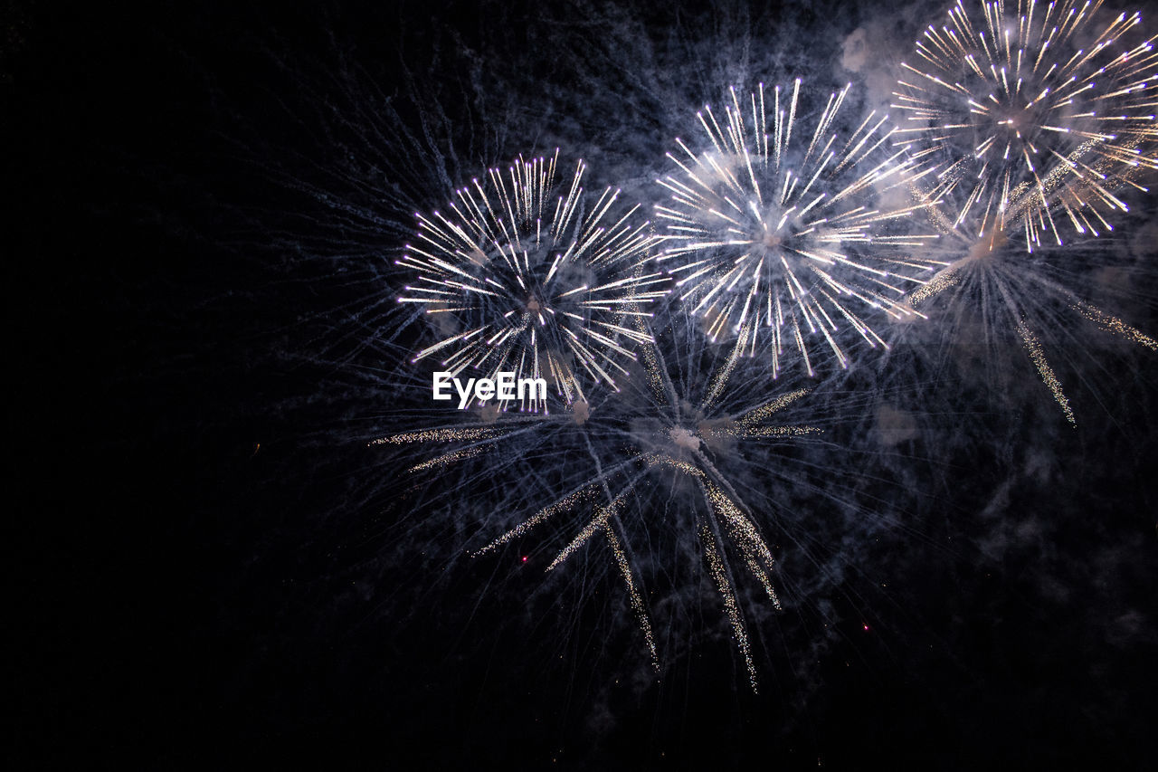 LOW ANGLE VIEW OF FIREWORKS IN SKY