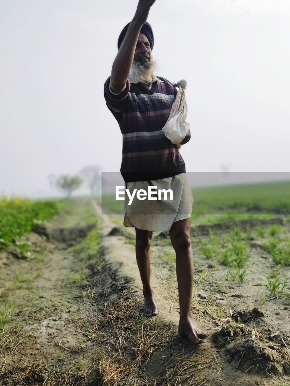 MAN STANDING ON FIELD