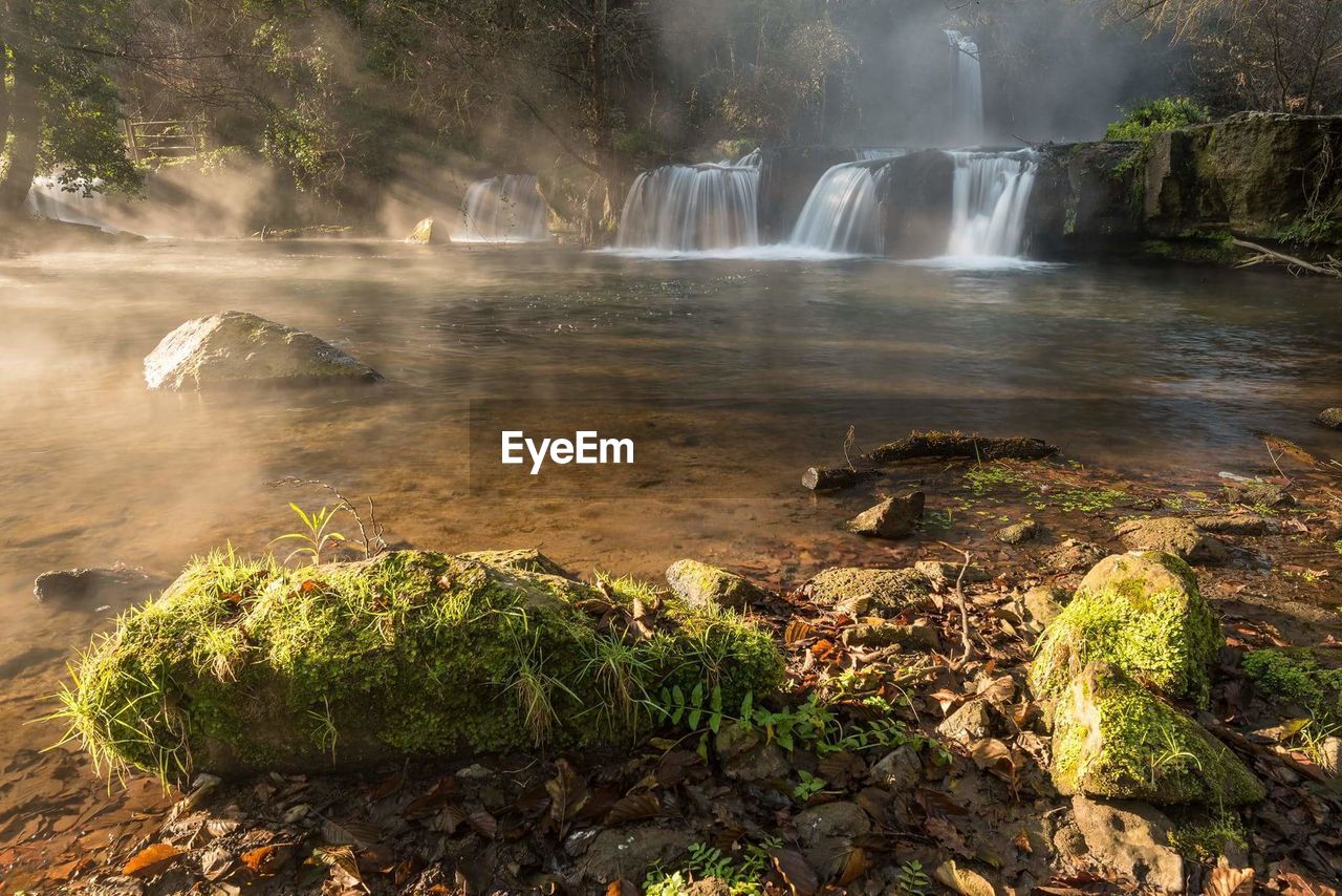 Scenic view of river flowing through rocks