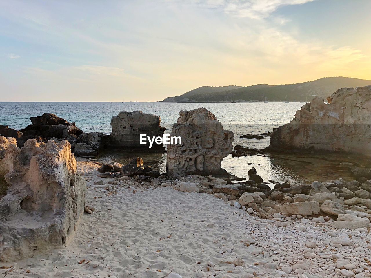 ROCKS ON SHORE AGAINST SKY