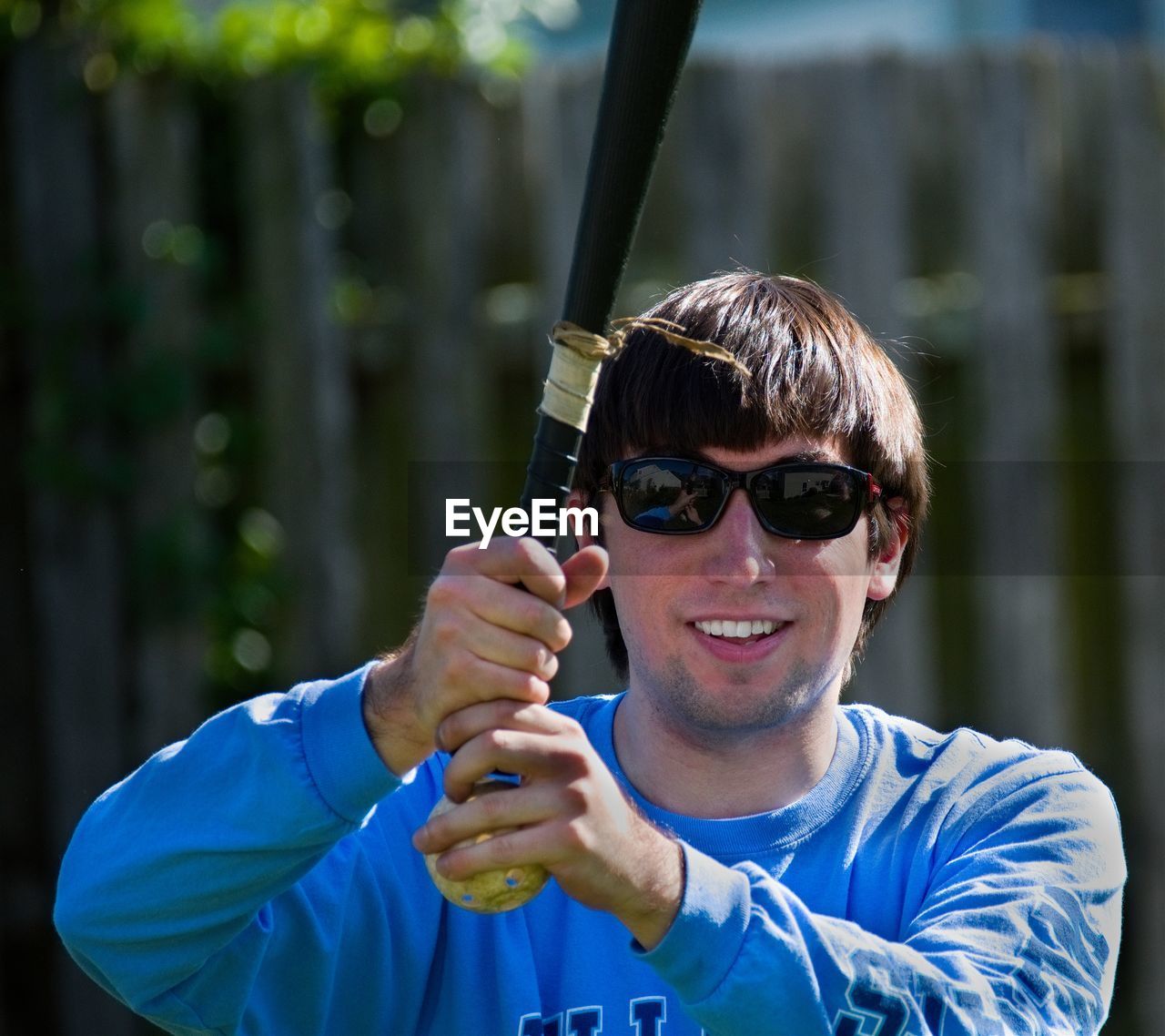 Portrait of smiling man holding baseball bat