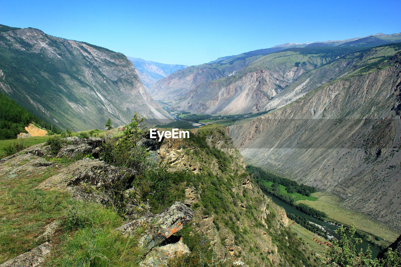 Rocky mountain slope overlooking the high-mountain chulyshman valley with the river in summer
