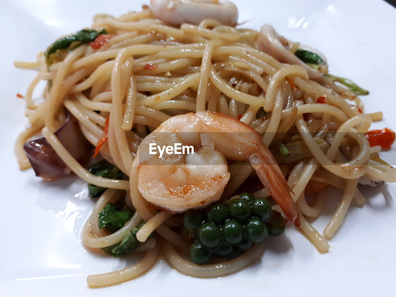 CLOSE-UP OF PASTA WITH VEGETABLES AND SALAD