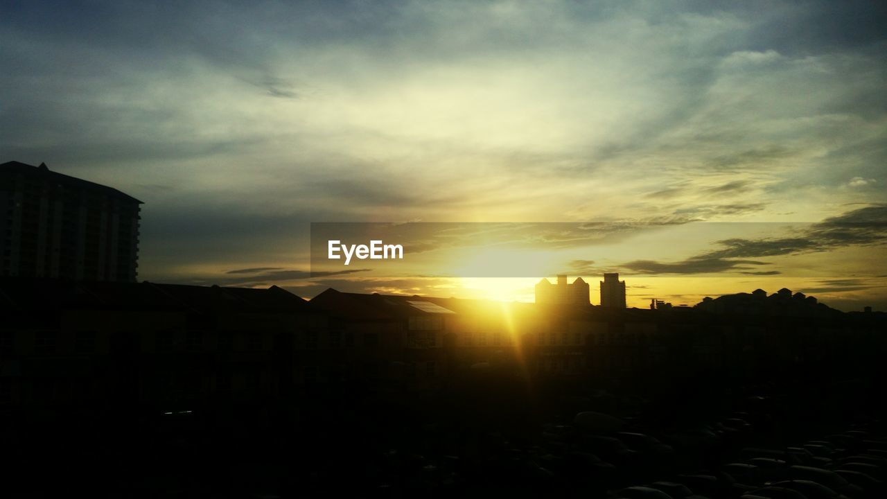 SILHOUETTE CITYSCAPE AGAINST SKY AT SUNSET