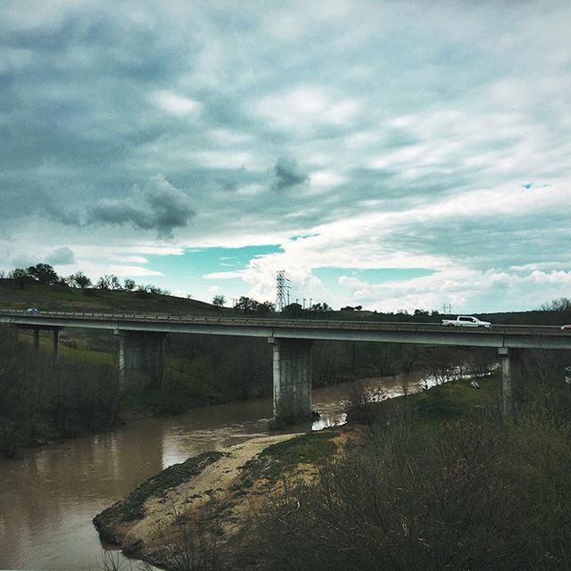 VIEW OF RIVER AGAINST CLOUDY SKY