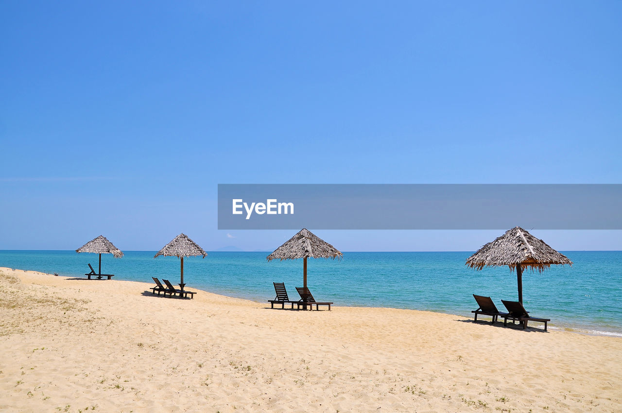 Sun loungers on calm beach