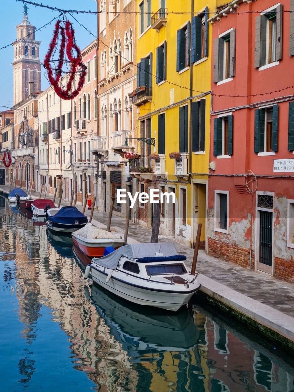 View of a venetian canal with reflections of historical buildings