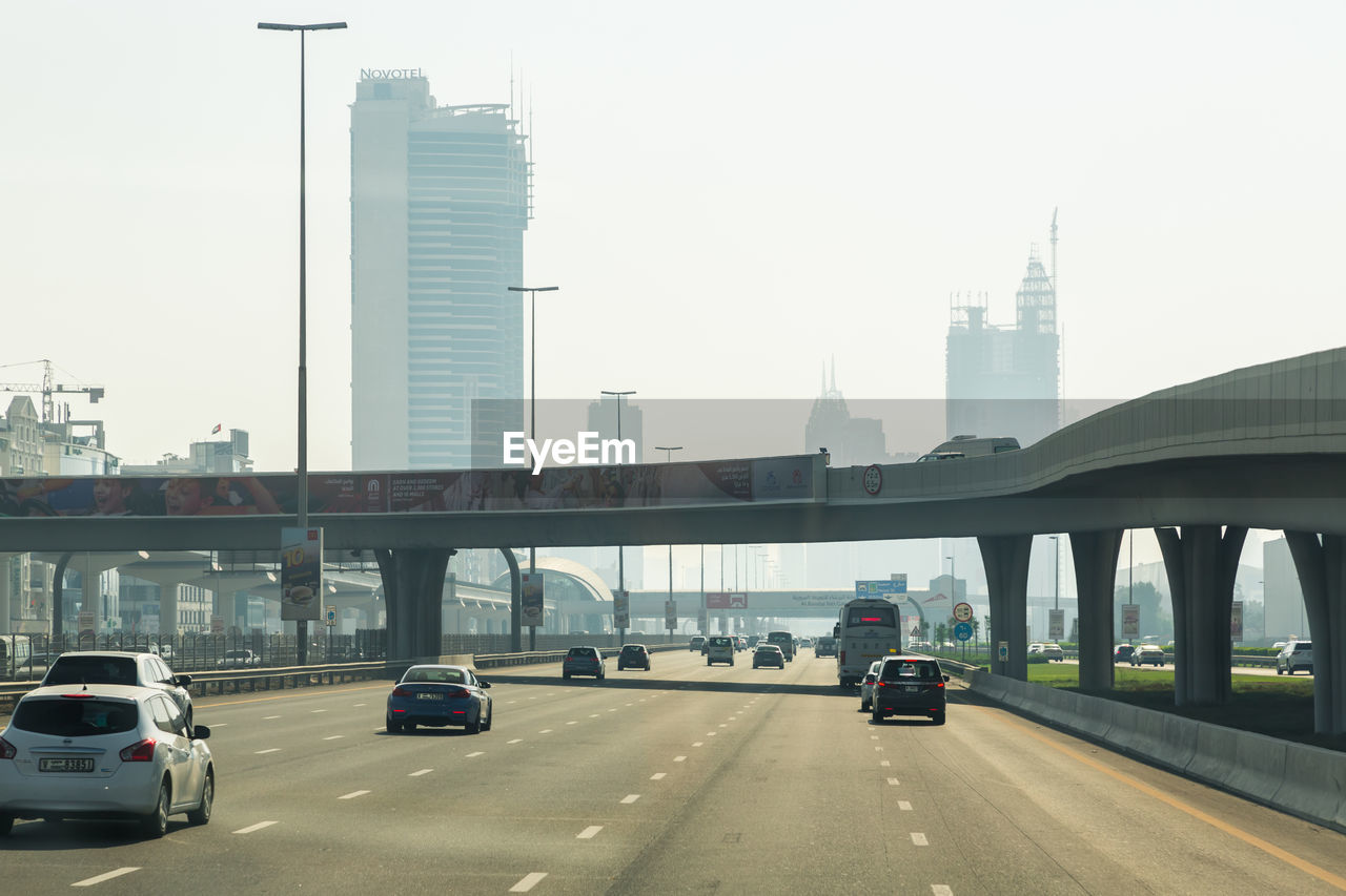 CARS ON BRIDGE AGAINST SKY