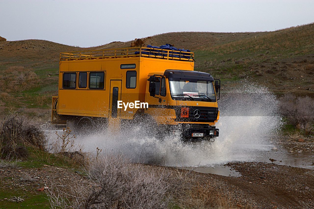 VIEW OF YELLOW CAR ON LAND