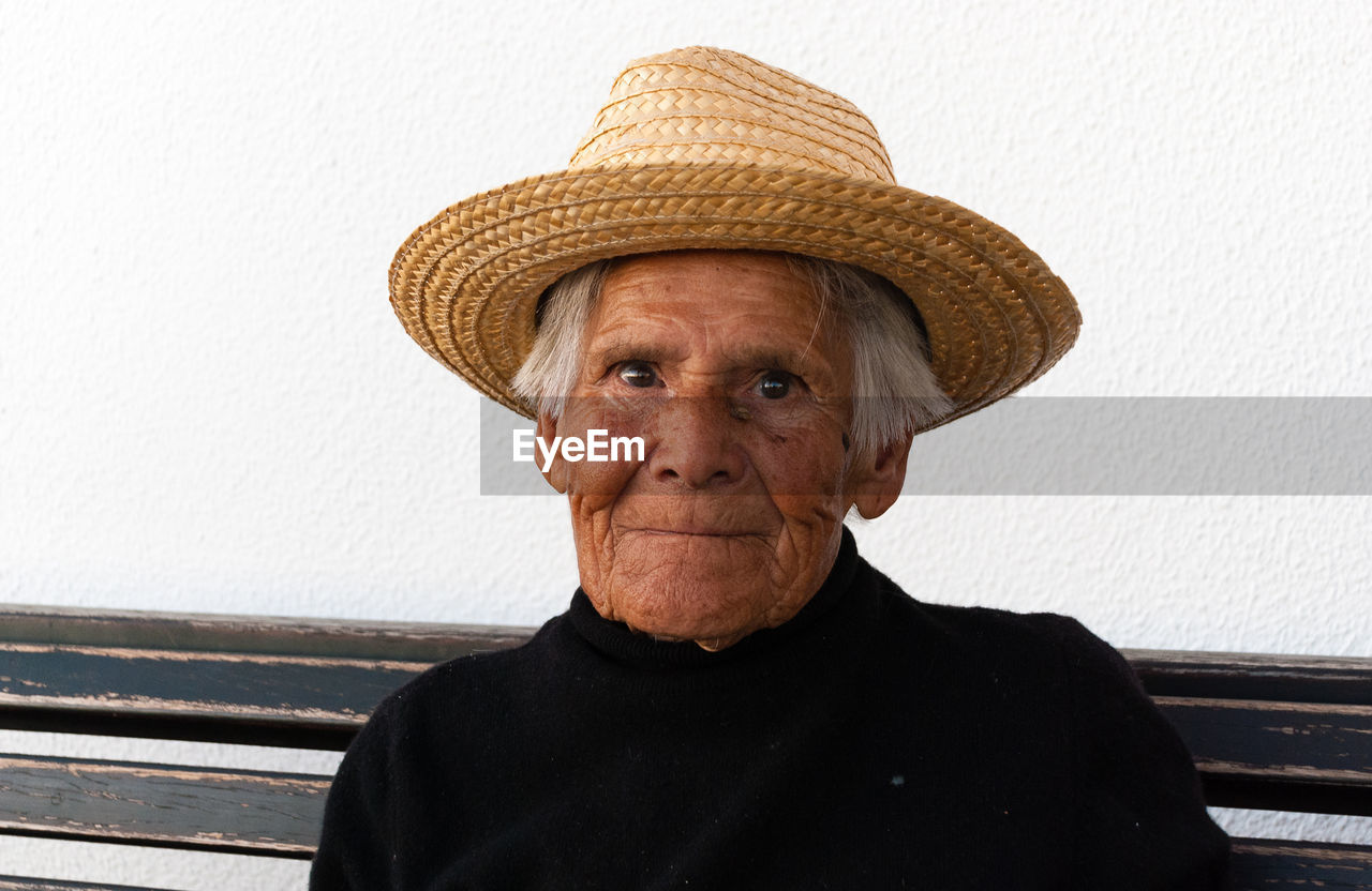 Close-up portrait of senior woman wearing hat