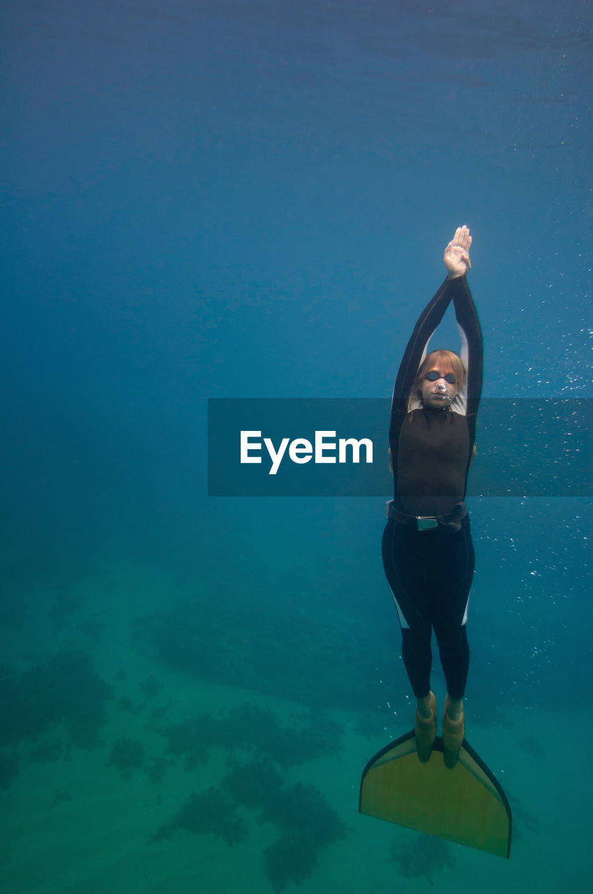 Woman scuba diving in sea