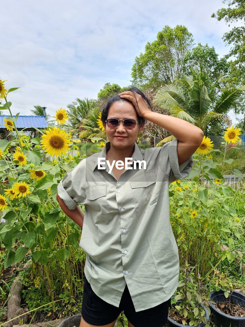 Low section of woman standing by tree