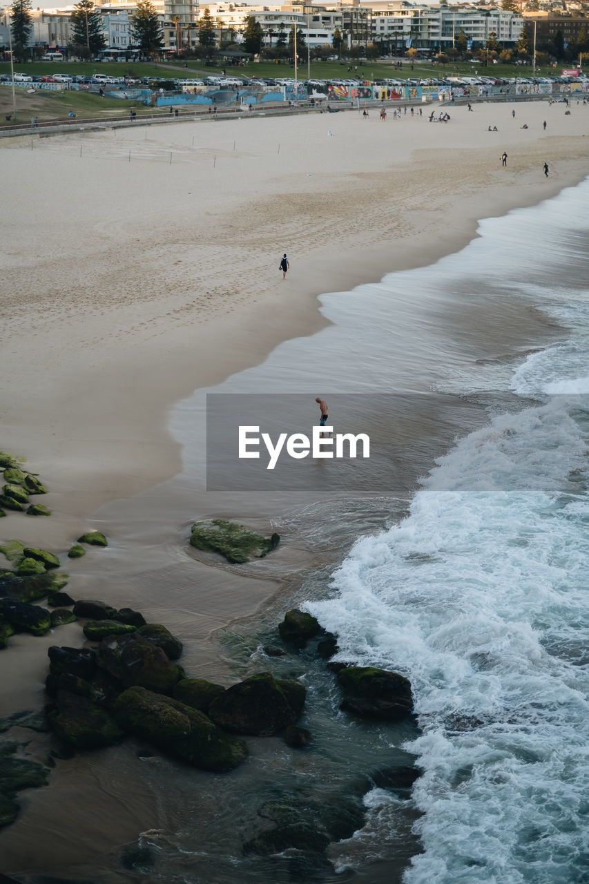 MAN SURFING ON BEACH