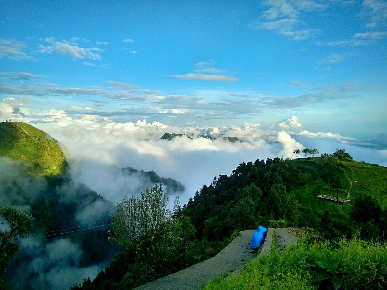 Scenic view of mountain and cloudscape against sky