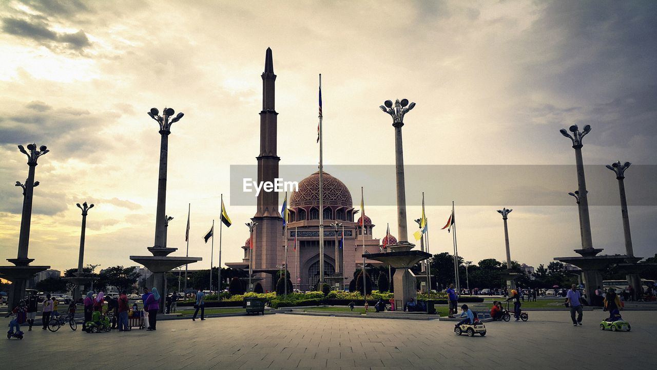 People visiting putra mosque against sky