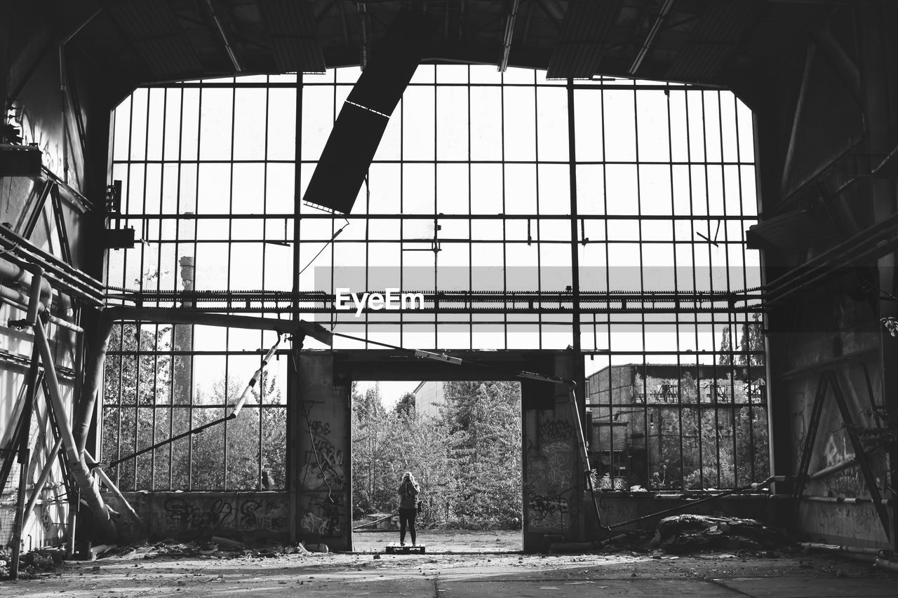 Low angle view of man in abandoned building