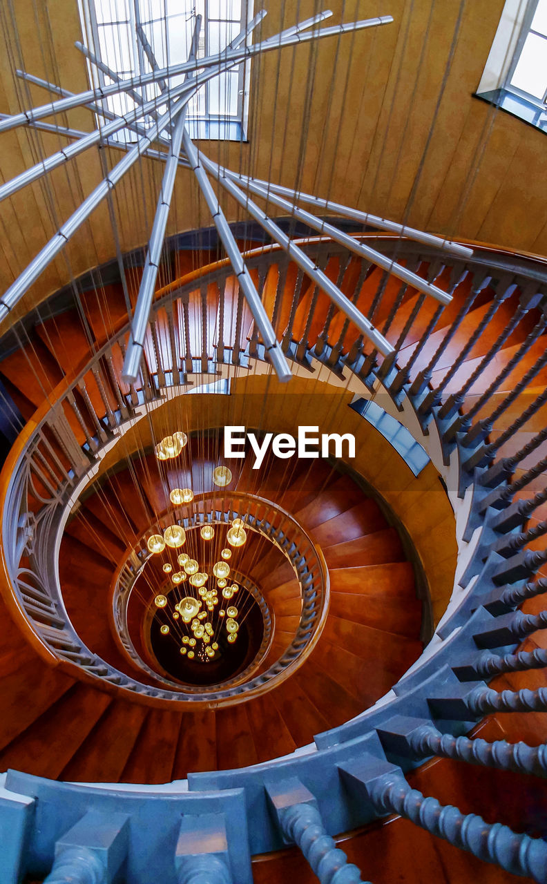 DIRECTLY BELOW SHOT OF SPIRAL STAIRCASE OF BUILDING