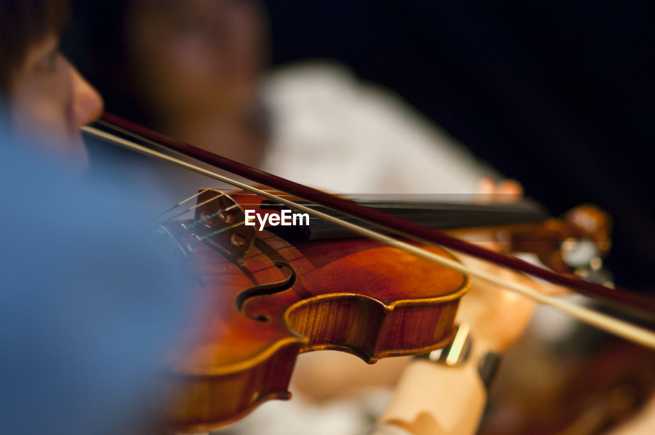 Close-up of woman playing violin