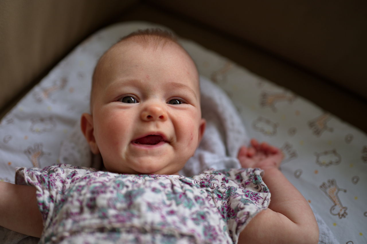 Portrait of little baby girl lying on the sofa