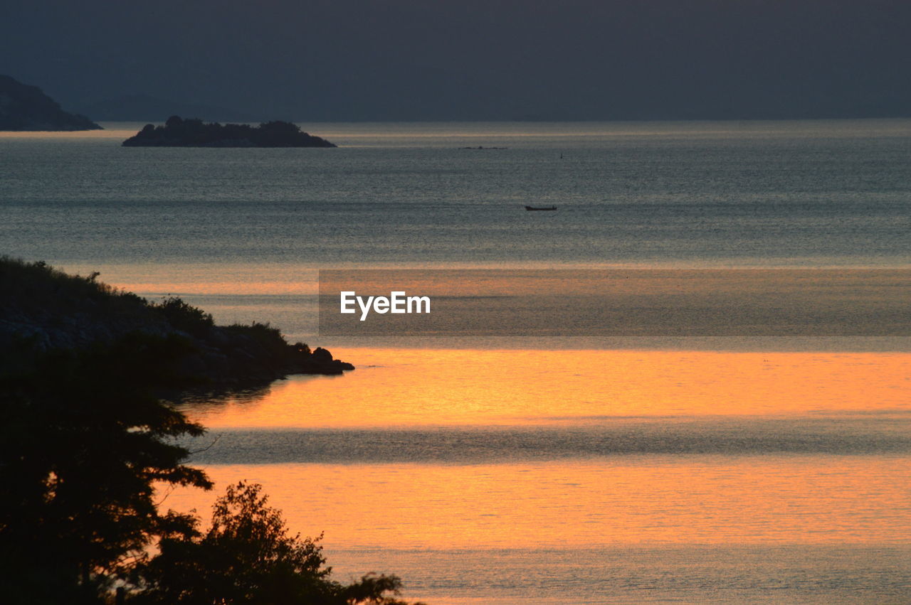 SCENIC VIEW OF SEA DURING SUNSET