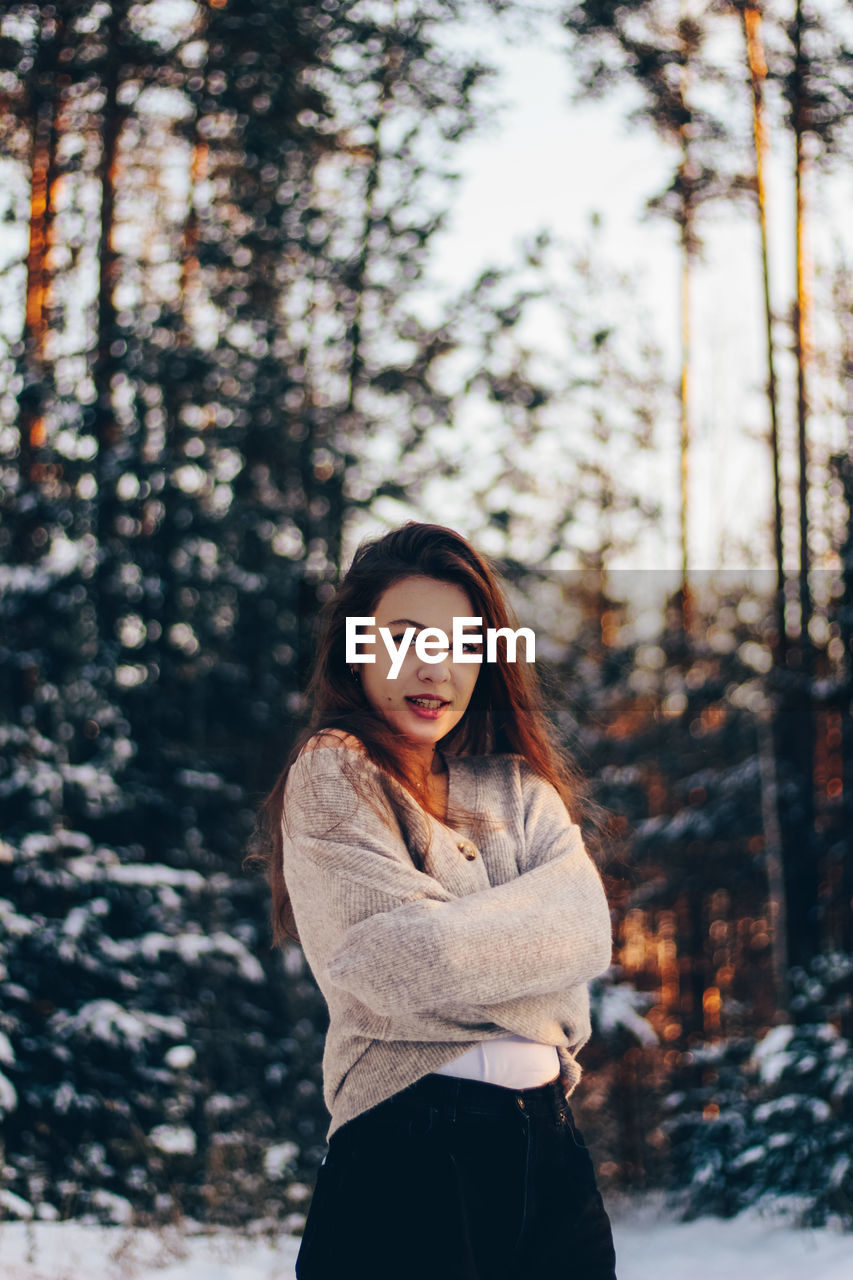 Portrait of beautiful young woman in forest