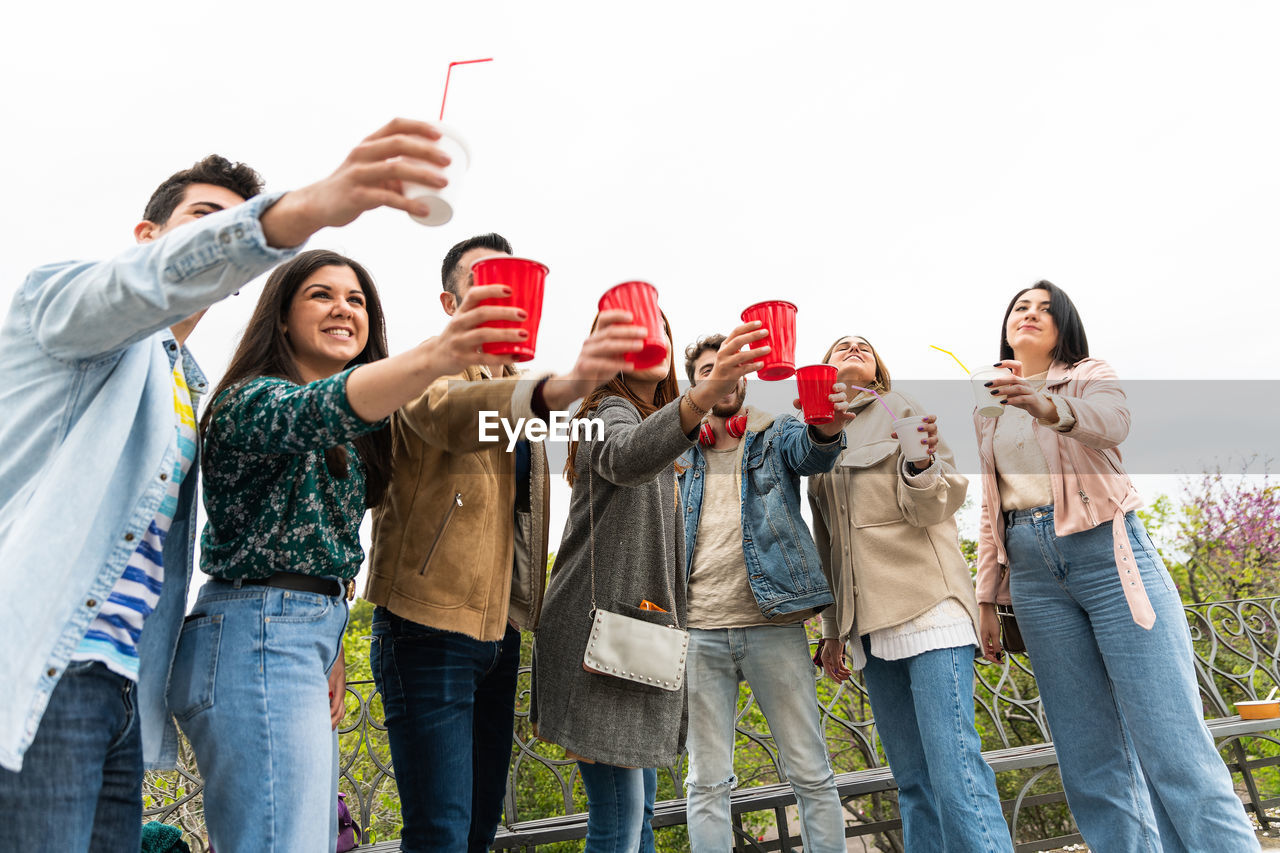 Happy diverse young people having fun delivery drink