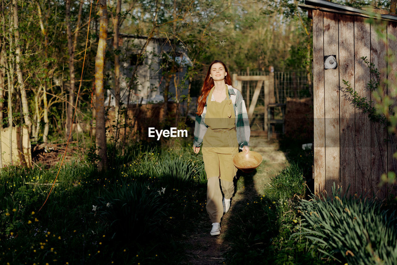 Portrait of young woman walking in forest