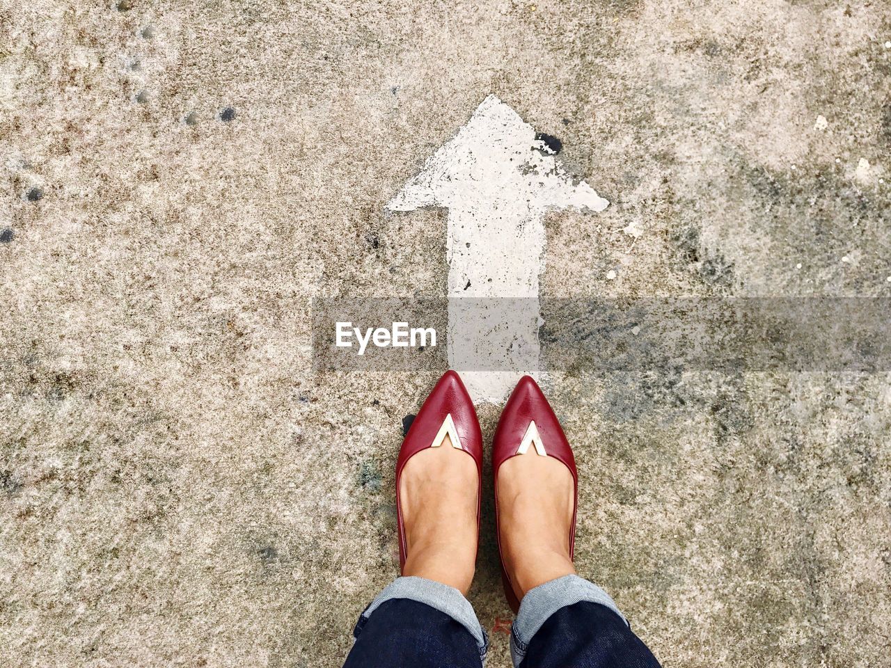 Low section of woman standing on street