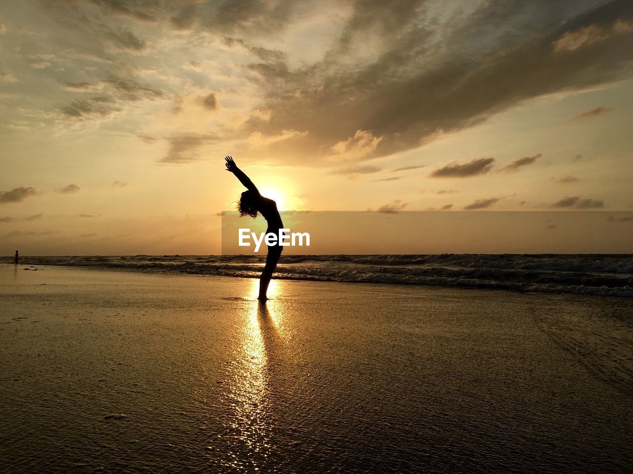 SILHOUETTE PERSON AT BEACH DURING SUNSET