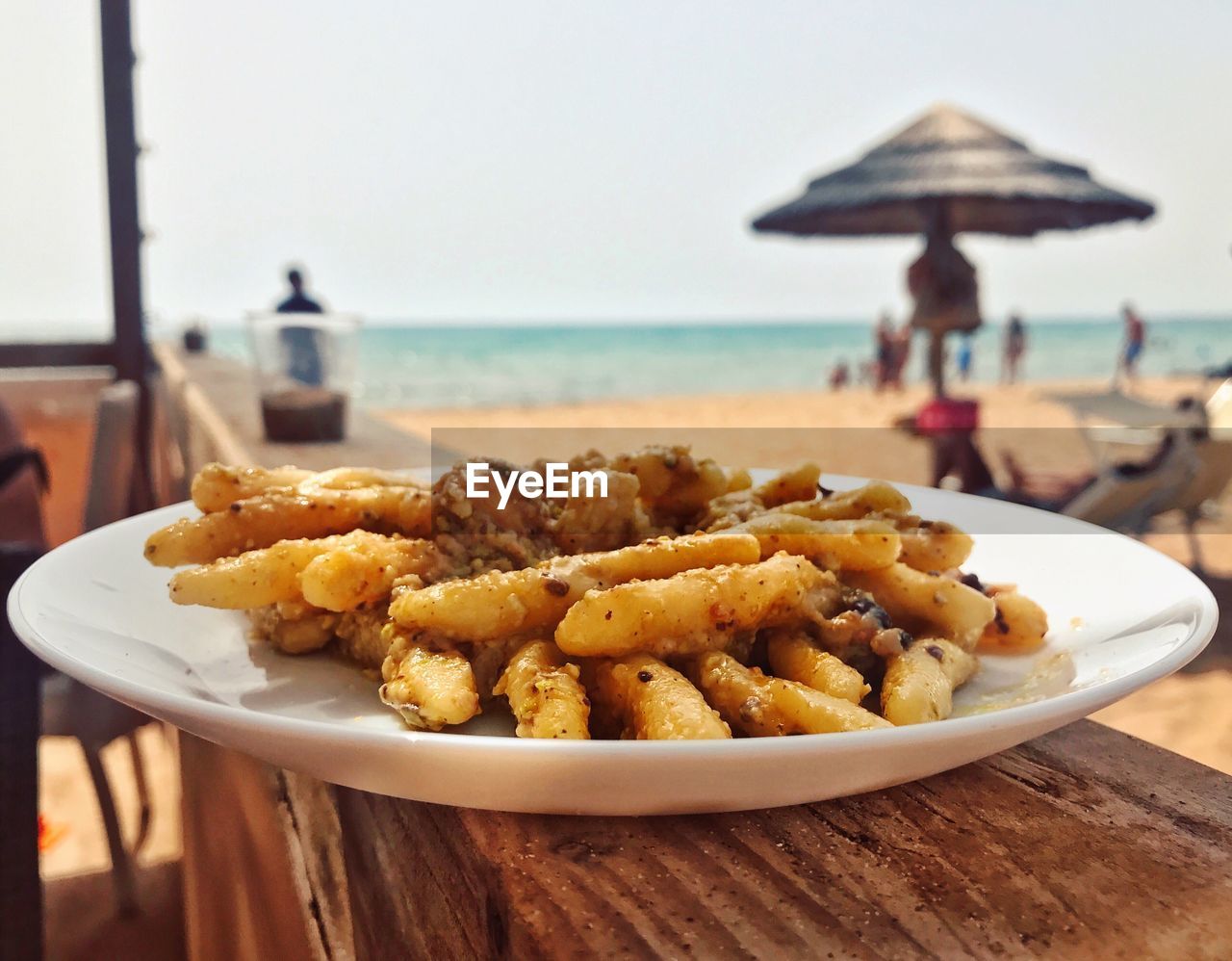 CLOSE-UP OF FOOD ON TABLE AT BEACH