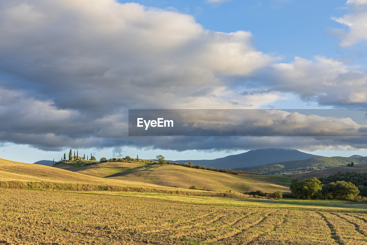 Italy, tuscany, clouds over rolling landscape of val d'orcia