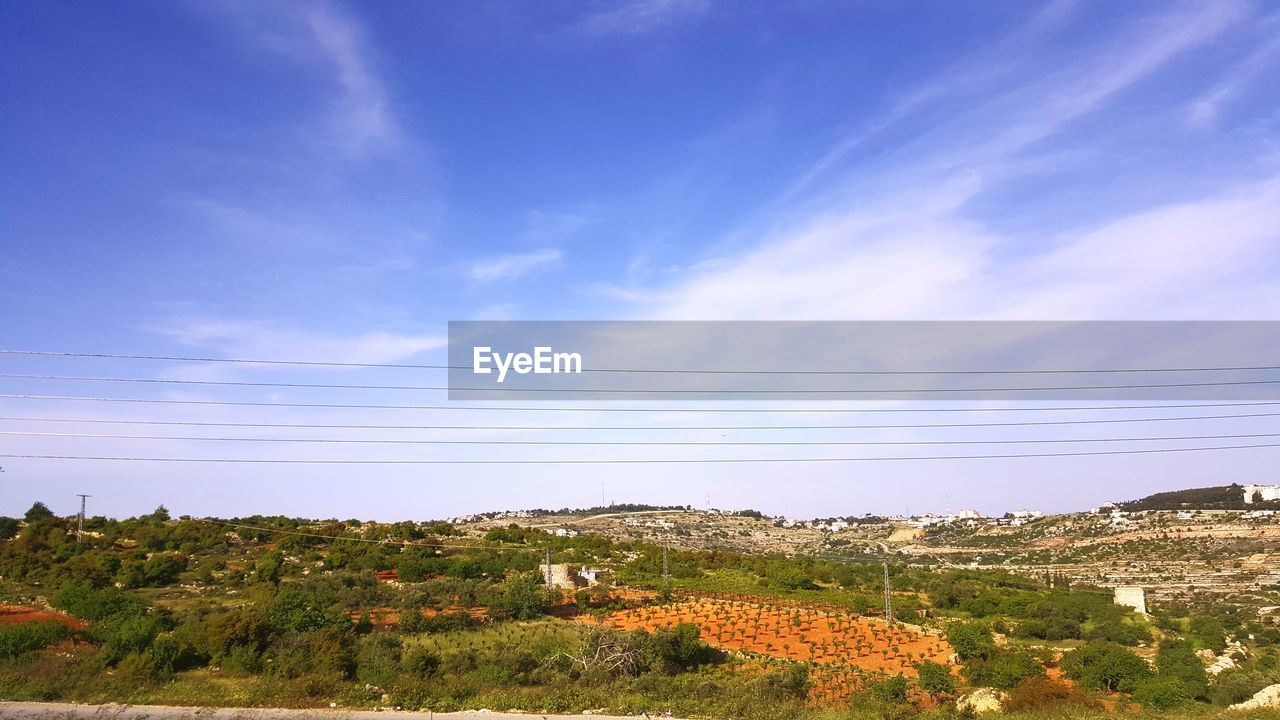 SCENIC VIEW OF LAND AGAINST SKY AND BUILDINGS