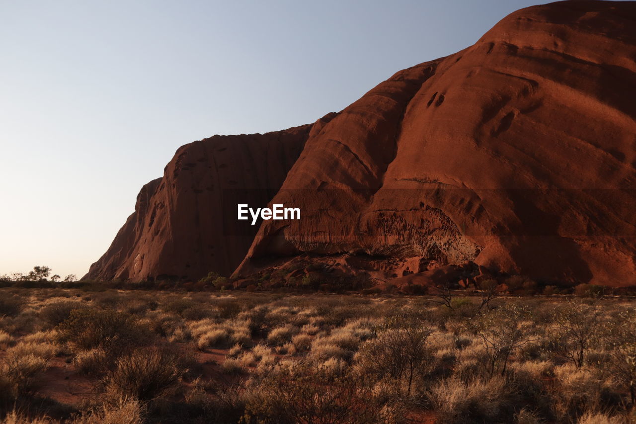 Rock formations on landscape against sky