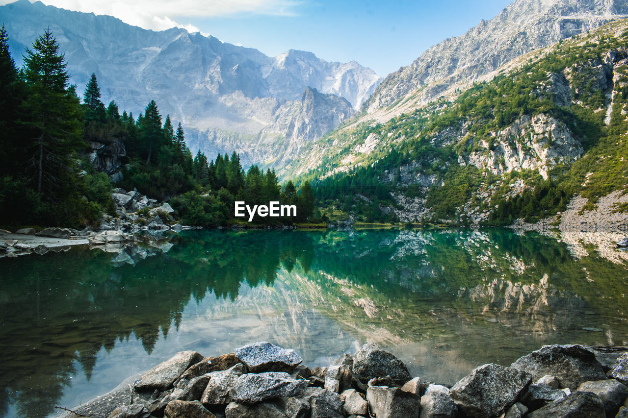 scenic view of lake and mountains against mountain