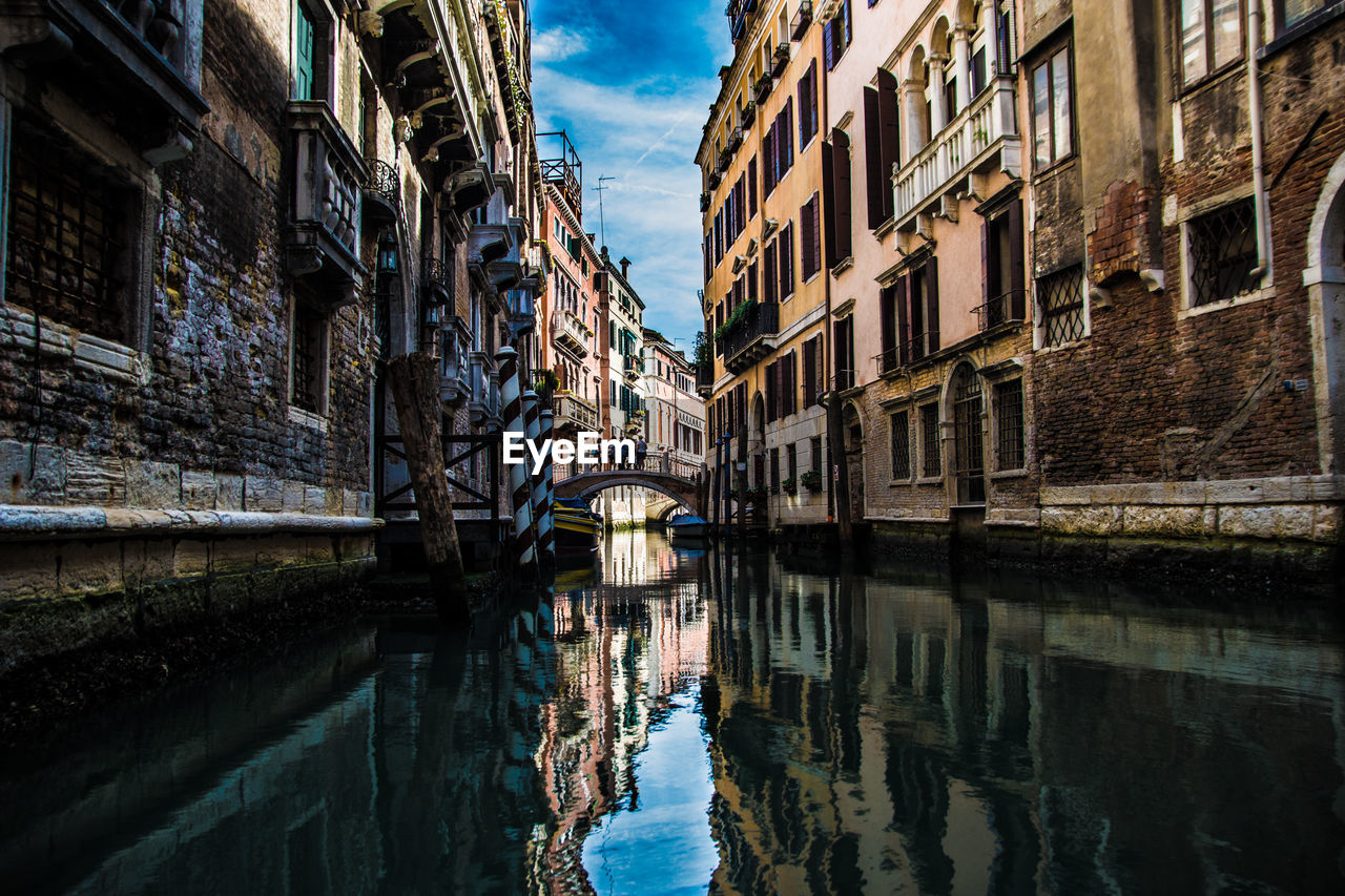 Canal amidst buildings in city