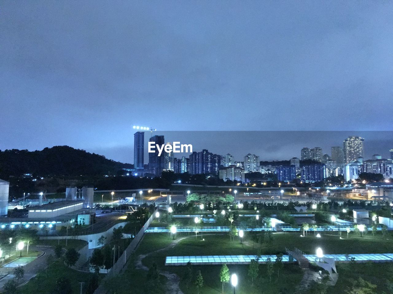 High angle view of illuminated buildings against sky at night