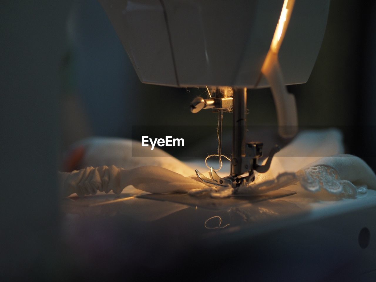 Close-up of sewing machine with fabric