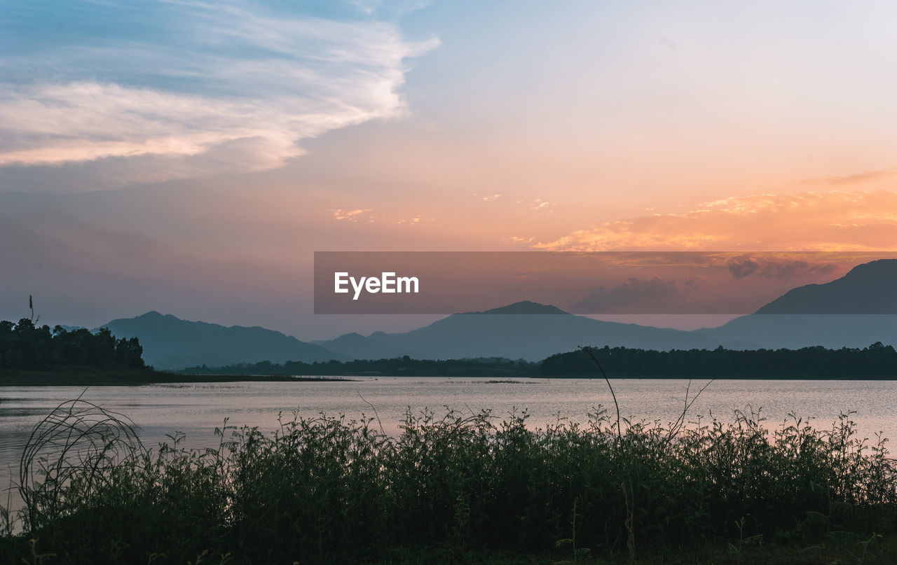 Scenic view of lake against sky during sunset