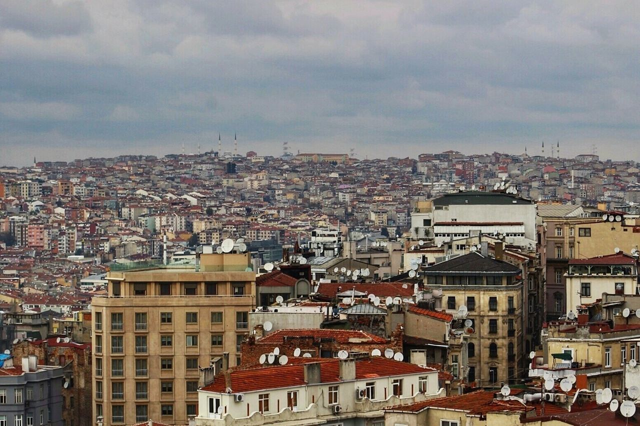 Cityscape against cloudy sky